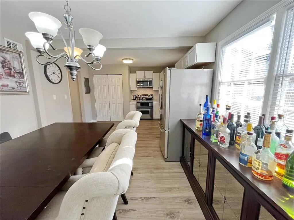 Dining area featuring a chandelier and light wood-style floors