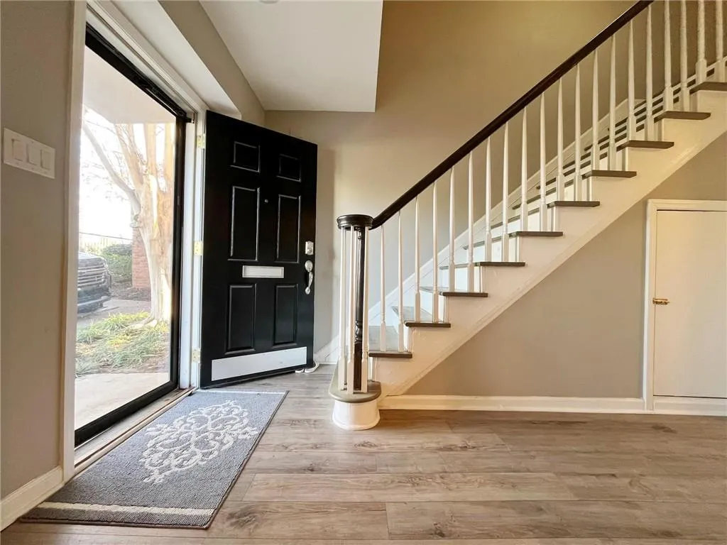Entryway with stairway and light wood-type flooring