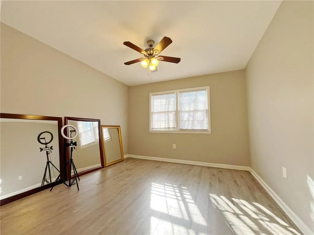 Spare room featuring light wood-type flooring and a ceiling fan