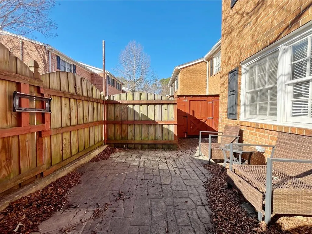 Fenced backyard with a gate and a residential view