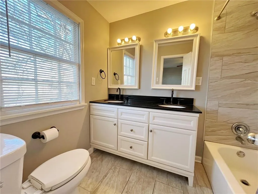 Full bath with shower / bath combination and double vanity