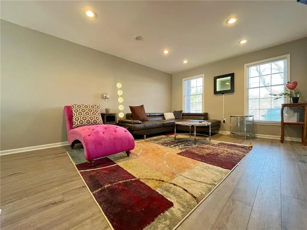 Living area featuring light wood-type flooring and recessed lighting