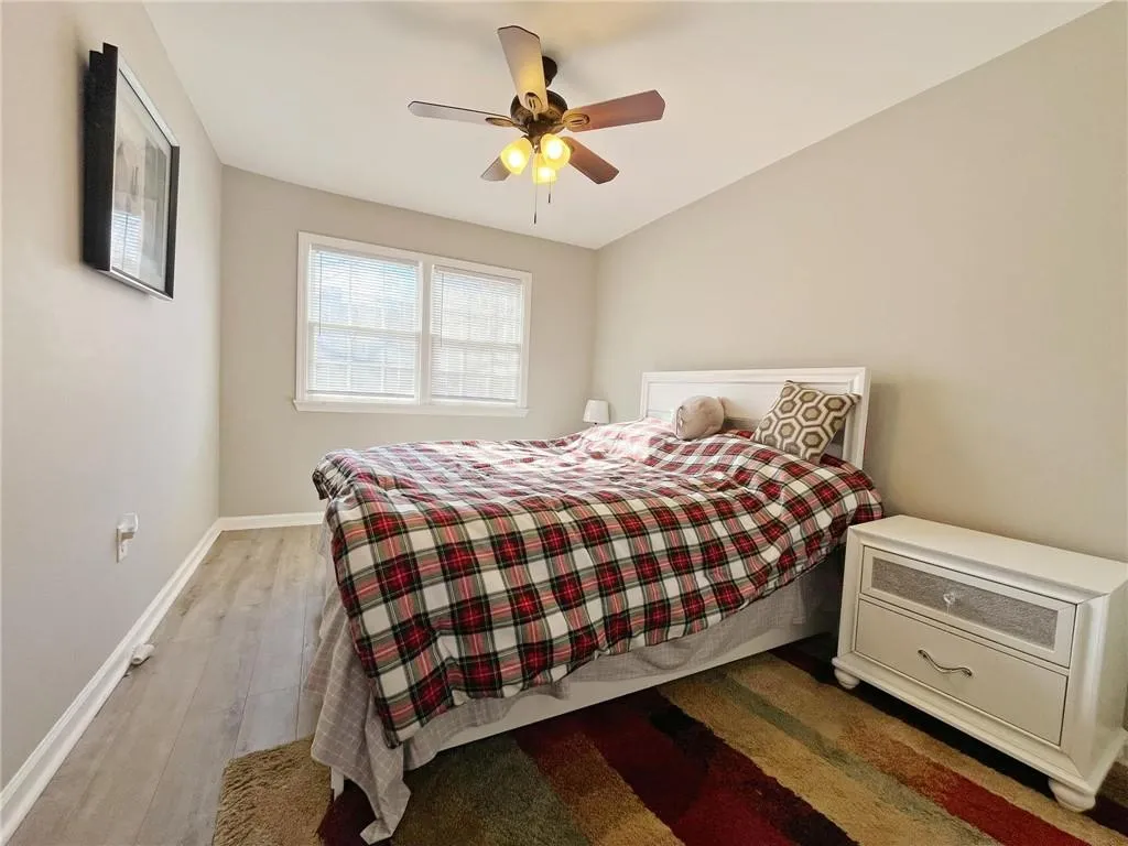 Bedroom with wood finished floors and ceiling fan