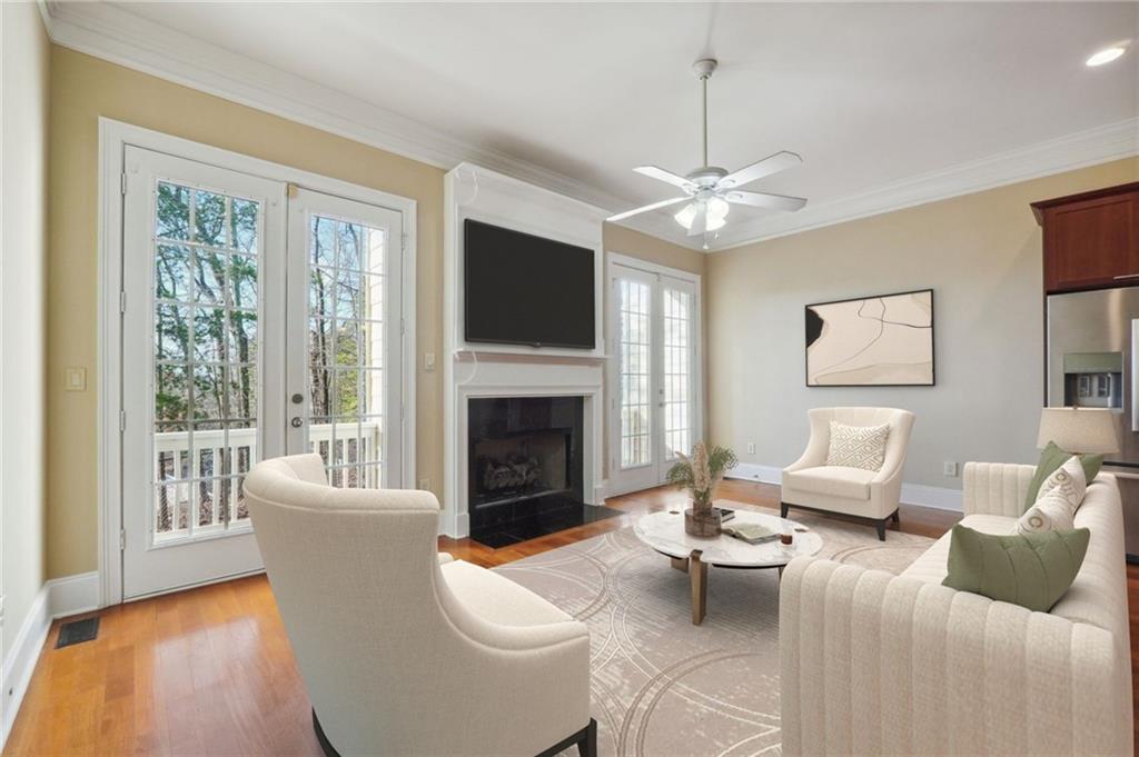 Virtual staged with light hardwood / wood-style flooring, crown molding, ceiling fan, and a wealth of natural light