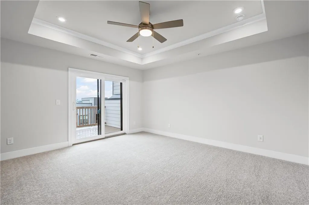 Primary bedroom with private deck, perfect for your morning coffee overlooking the Atlanta skyline