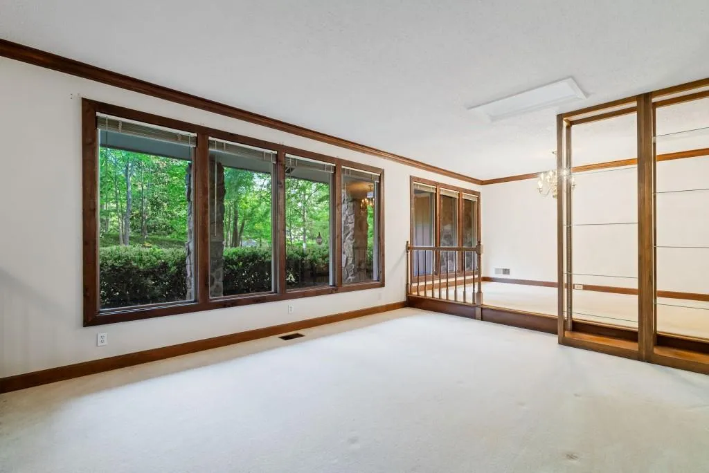 The sunken formal living room and elegant dining room add a splash of retro glam, ideal for hosting memorable gatherings.