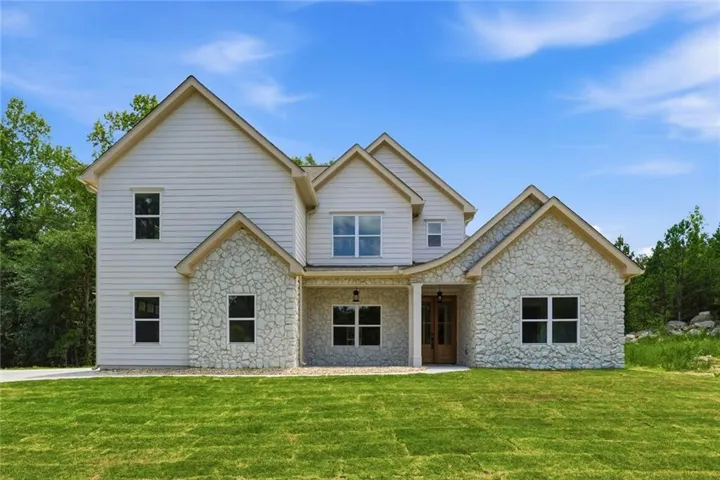 Architectural exterior featuring a blend of stone veneer and horizontal siding