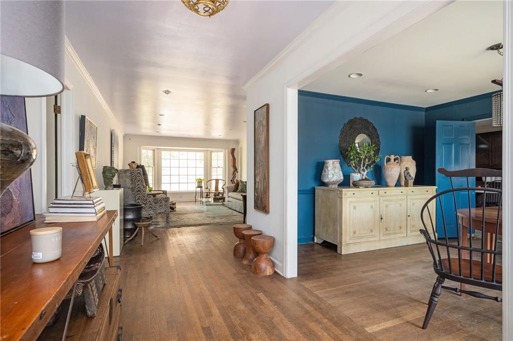 Hallway featuring wood floors.