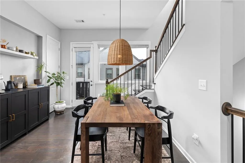 Dining space featuring stairway and dark wood-style floors