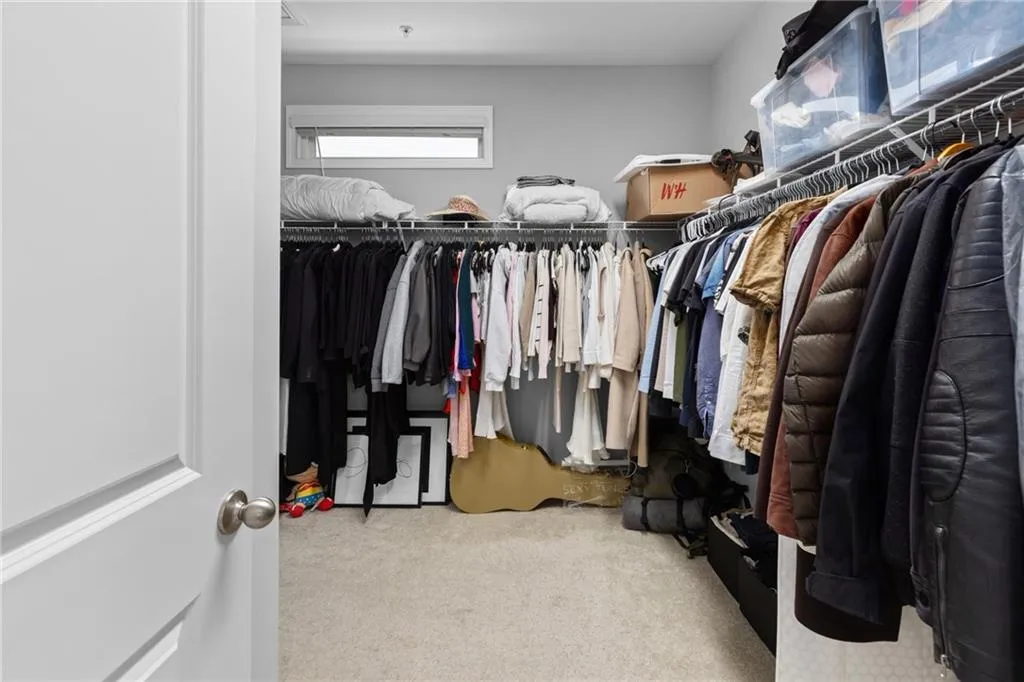 Spacious closet with light colored carpet