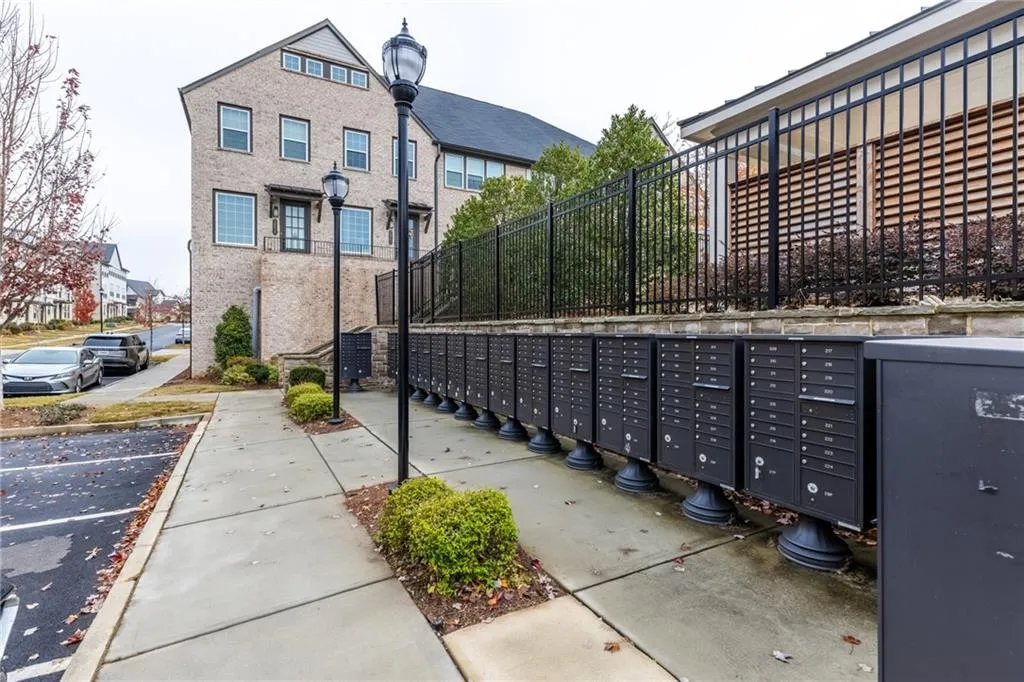 Surrounding community with mail area and uncovered parking