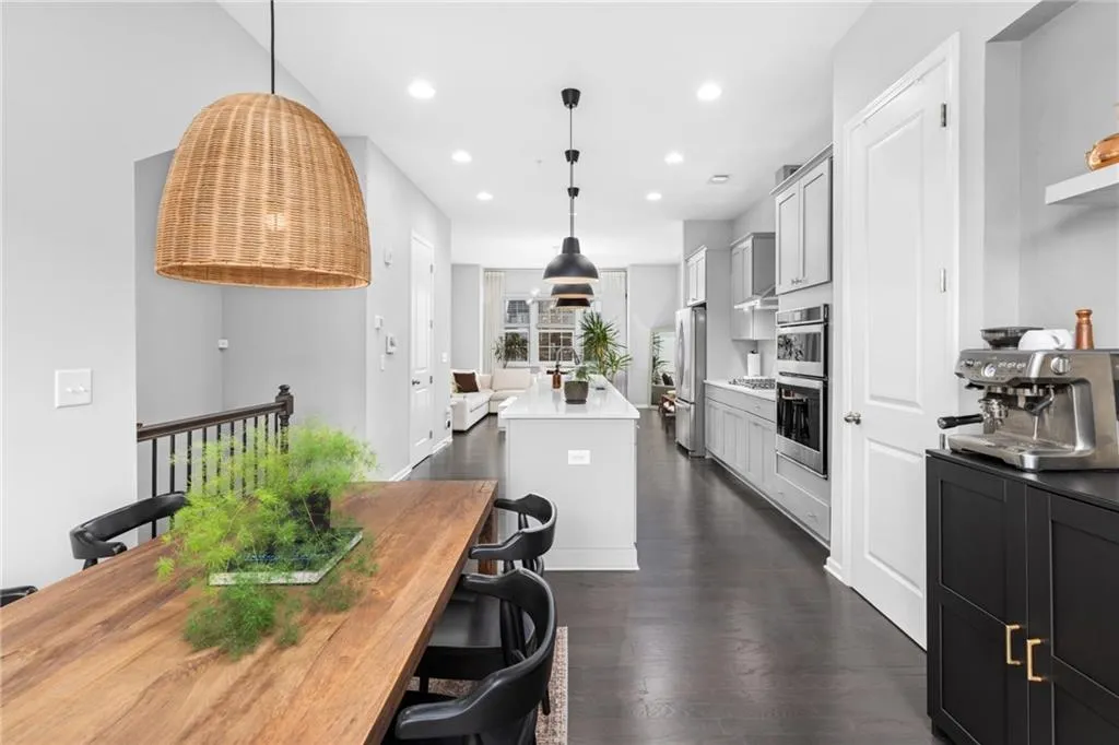 Kitchen featuring recessed lighting, hanging light fixtures, dark wood-style flooring, a center island, and stainless steel appliances