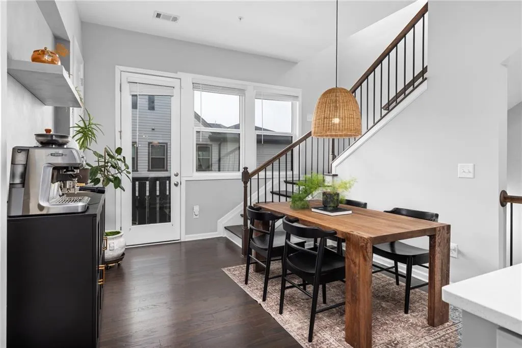 Dining area featuring stairway and dark wood-type flooring