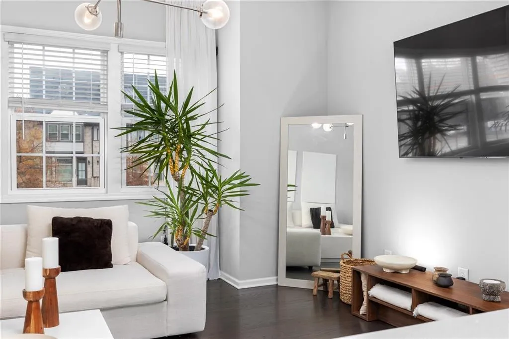 Living area with dark wood-type flooring and baseboards