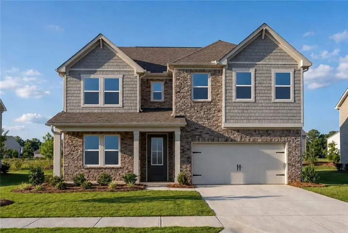 Two-story exterior featuring a prominent gable roofline, stone veneer and shake siding, an attached two-car garage, covered entry, and a concrete driveway