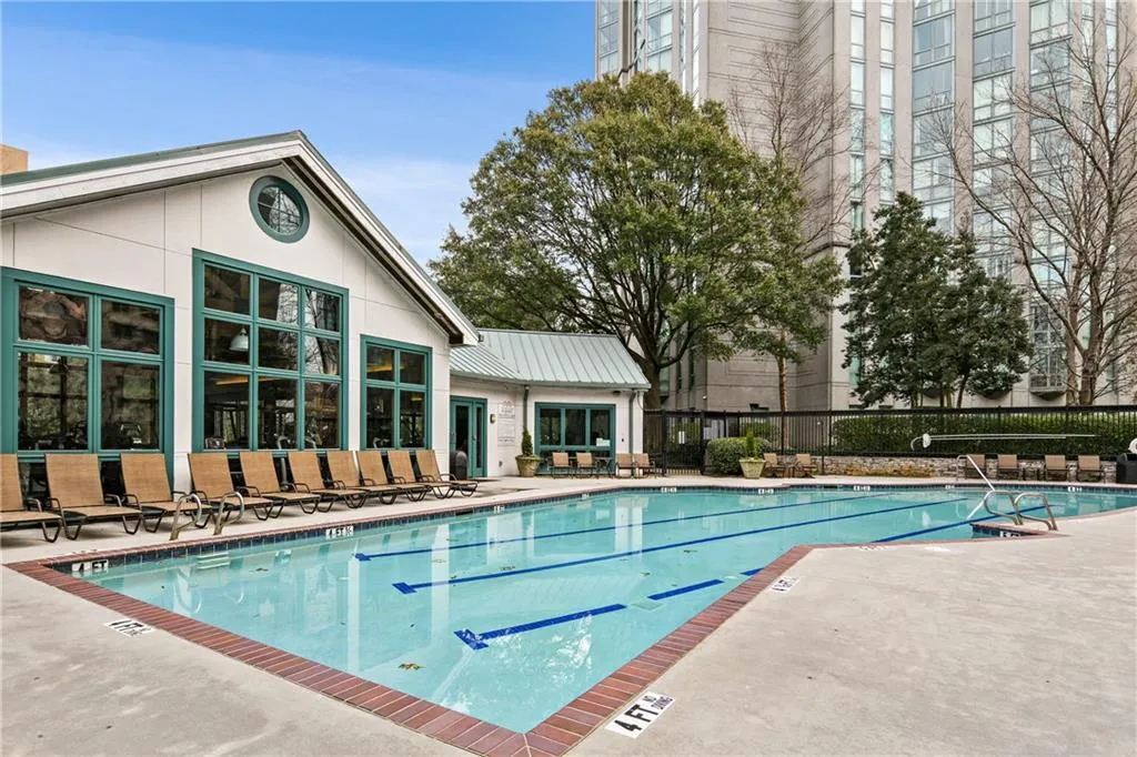 Pool featuring a patio and fence