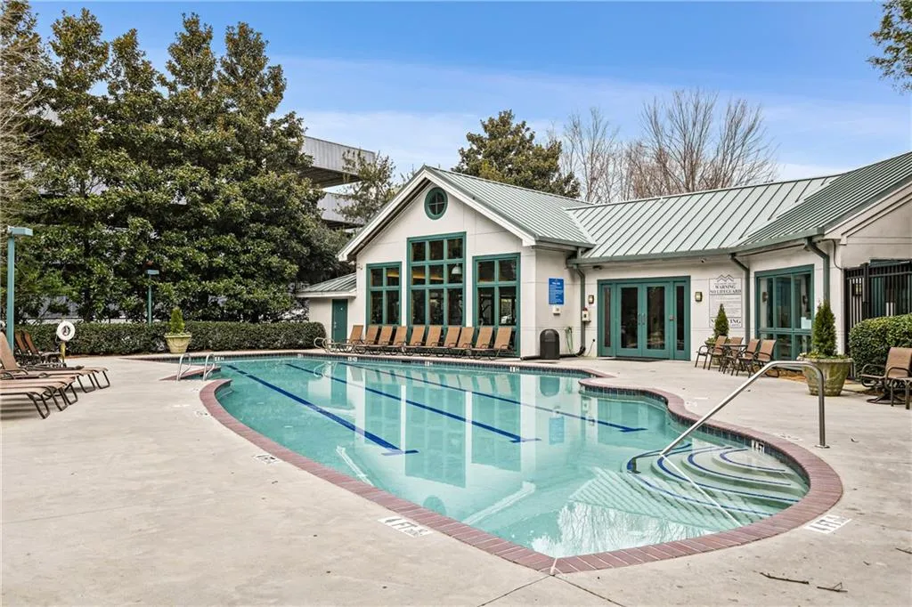 Community pool featuring french doors and a patio