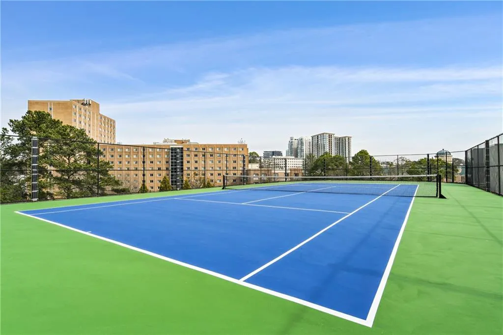 View of sport court with a view of city and fence