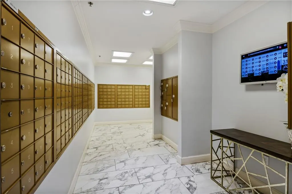 Hall with crown molding, recessed lighting, baseboards, marble finish floor, and mail area