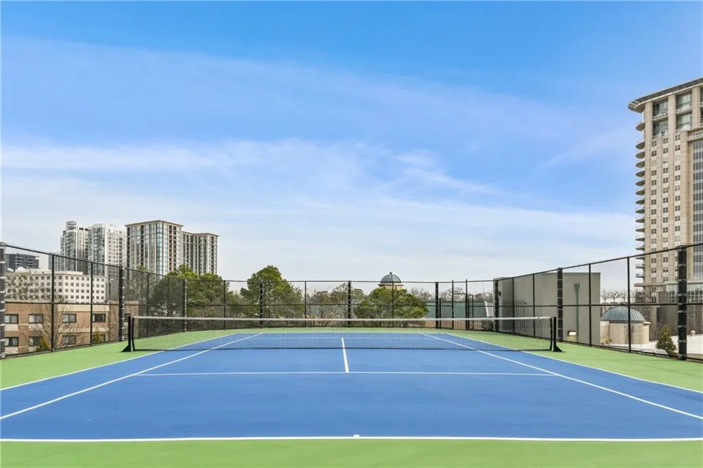 View of sport court with a view of city and fence