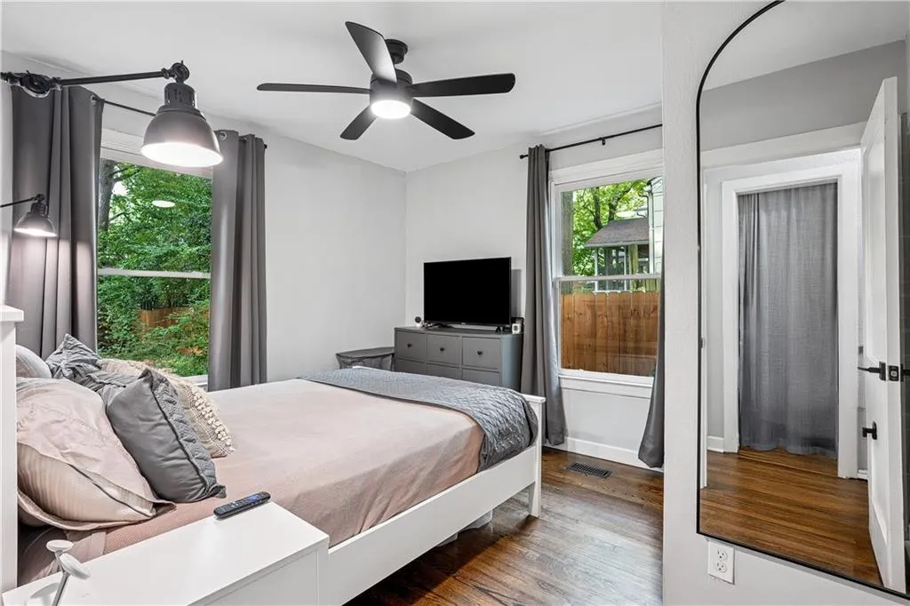 Bedroom featuring dark wood-type flooring and ceiling fan