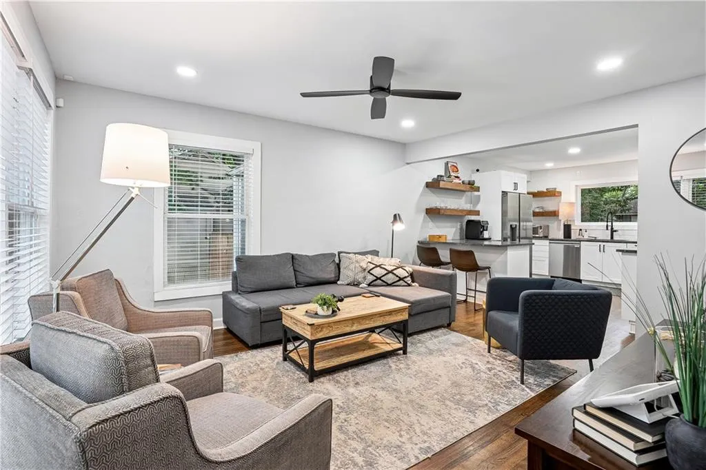 Living room featuring wood finished floors, recessed lighting, and a ceiling fan