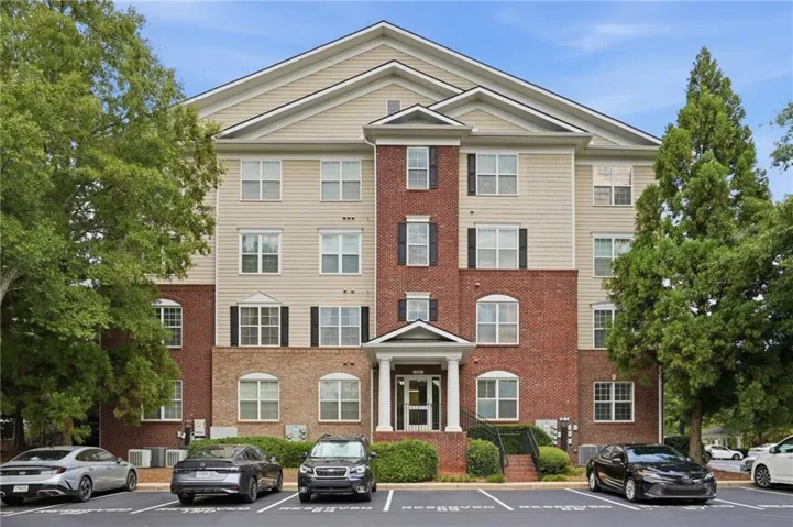 Multi-story building featuring brick and siding facade