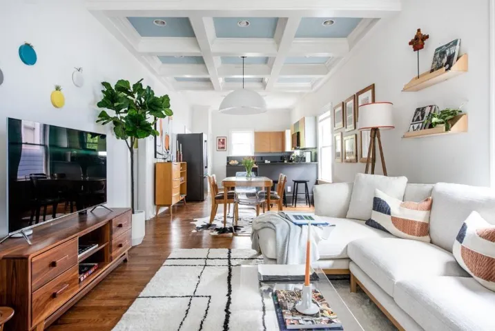 Living room featuring dark hardwood / wood-style floors, coffered ceiling, and beamed ceiling