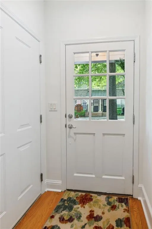 Doorway with light hardwood / wood-style flooring
