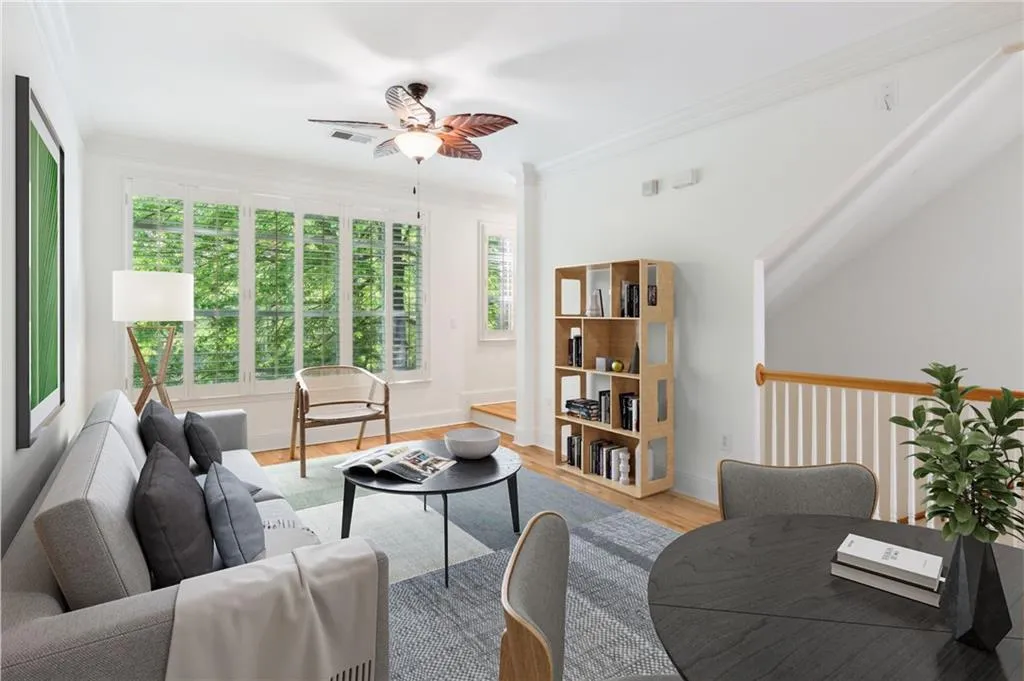 Living room featuring ceiling fan, light hardwood / wood-style floors, and ornamental molding