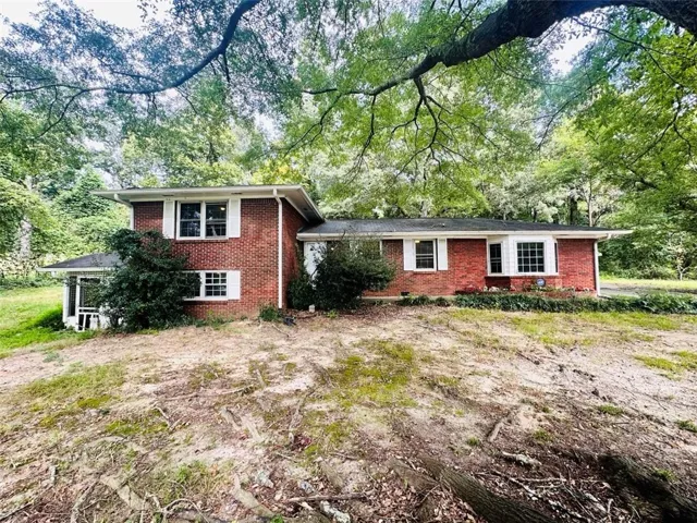 Brick exterior with white window shutters and trim