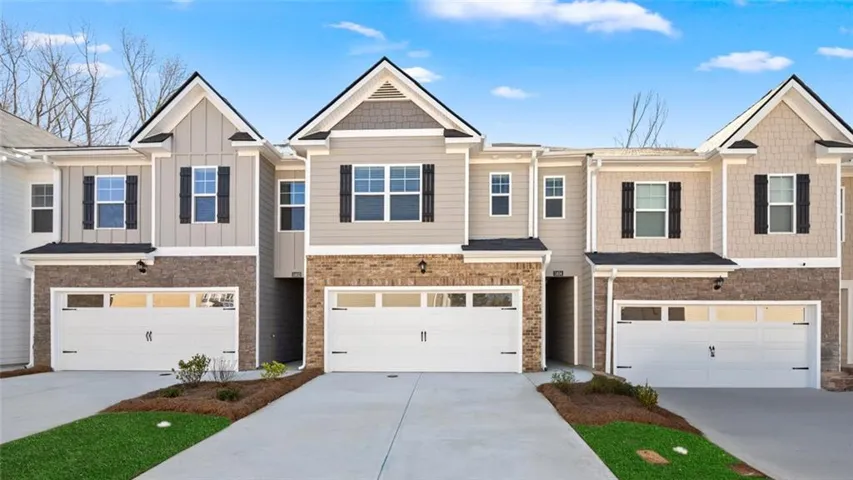 Exterior featuring a combination of horizontal siding, vertical siding, and stone veneer