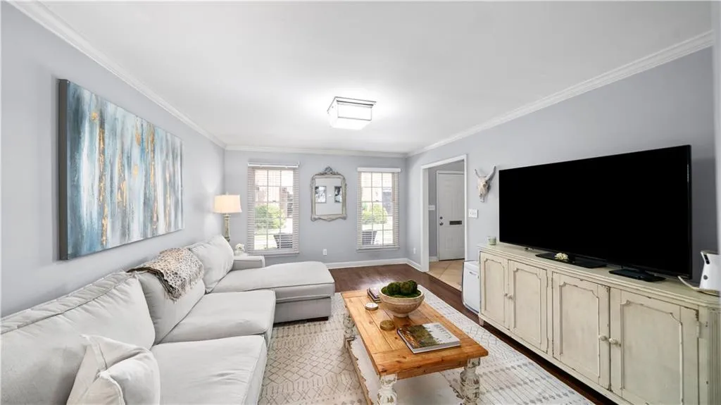 Living room featuring light hardwood / wood-style floors and crown molding