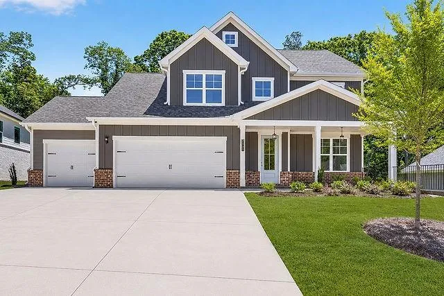 Contemporary two-story exterior with dark gray vertical siding and white trim