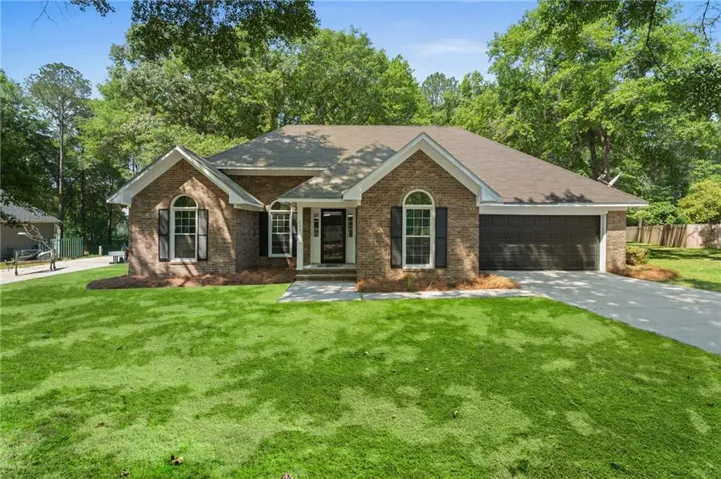 Brick exterior with arched windows, dark shutters, and an attached two-car garage