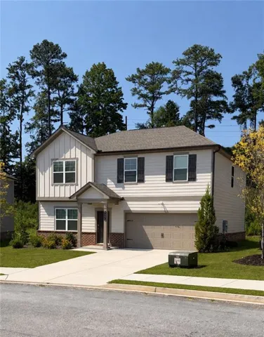 Two-story residence featuring a two-car garage, covered entry, and a combination of horizontal siding and board and batten accents