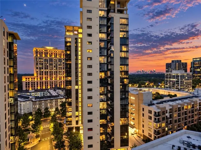 Modern high-rise residential building with expansive window lines and private balconies