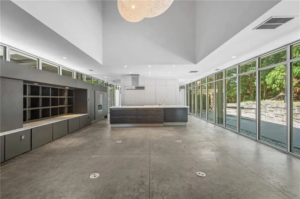 Welcome area featuring expansive windows, a towering ceiling, and recessed lighting