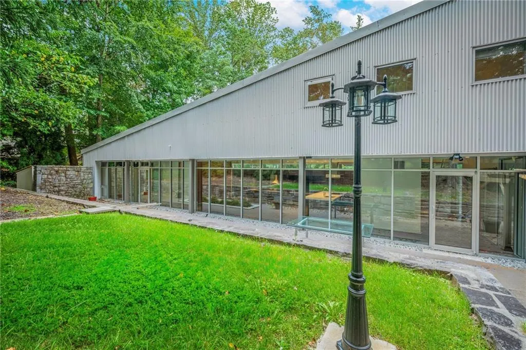Back of property with a lawn