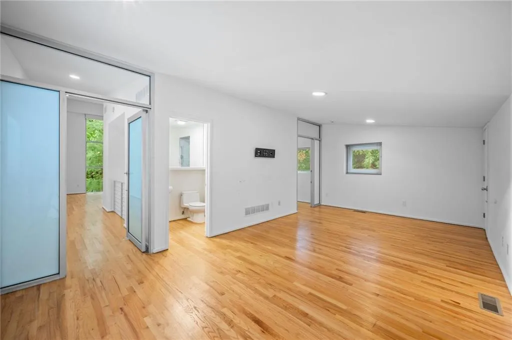 Spare room with light wood-type flooring and recessed lighting