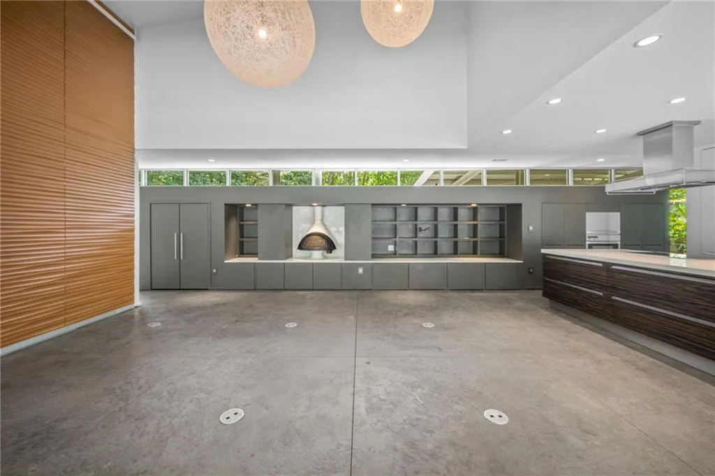 Unfurnished living room featuring recessed lighting, a towering ceiling, and concrete flooring