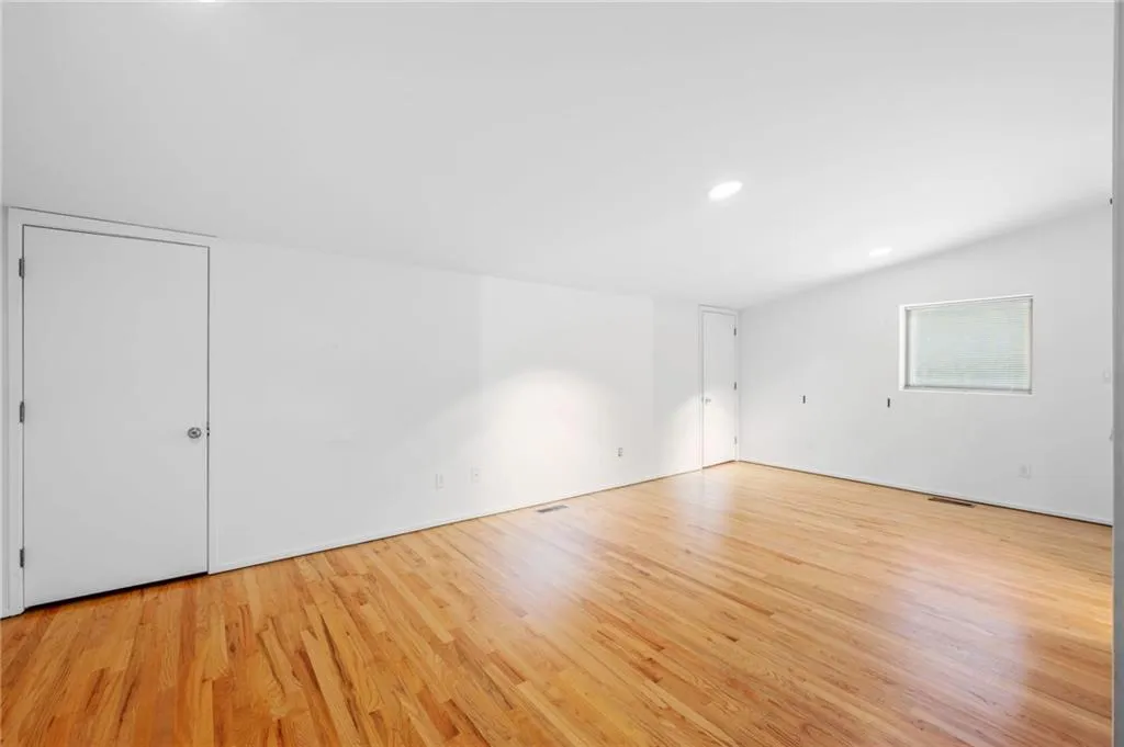Empty room featuring light wood finished floors and recessed lighting
