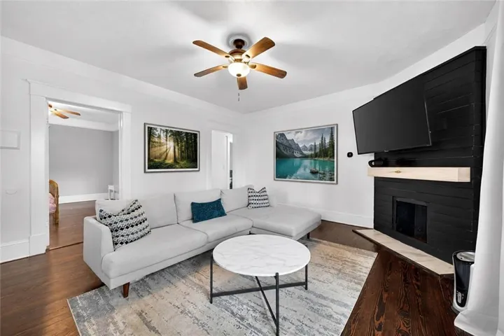 Living area featuring a dark wood-finish floor and a white ceiling