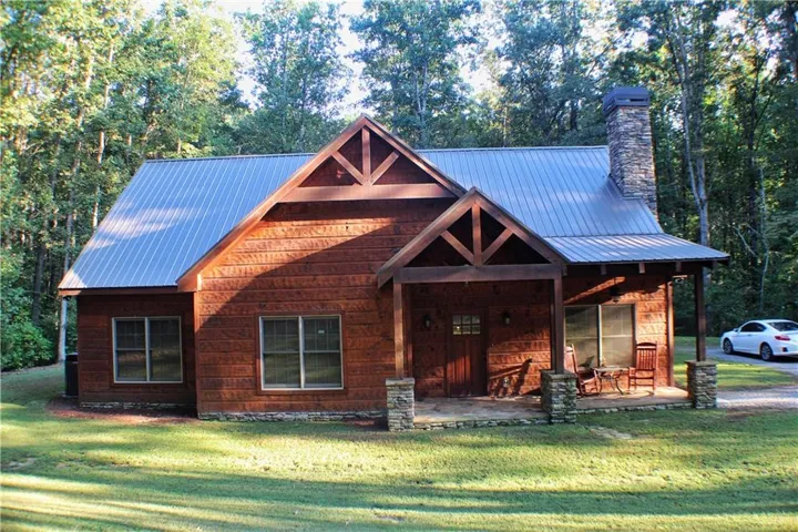 Wood-clad exterior with a metal roof and stone accents