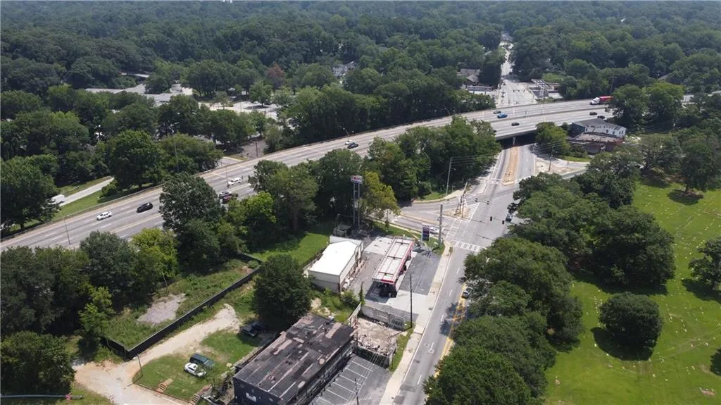 Aerial overview of property's location with a main thoroughfare and a forest