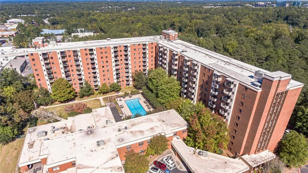 Drone / aerial view of apartment complex and a pool