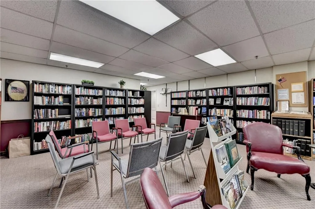 Office space featuring bookshelves and a paneled ceiling