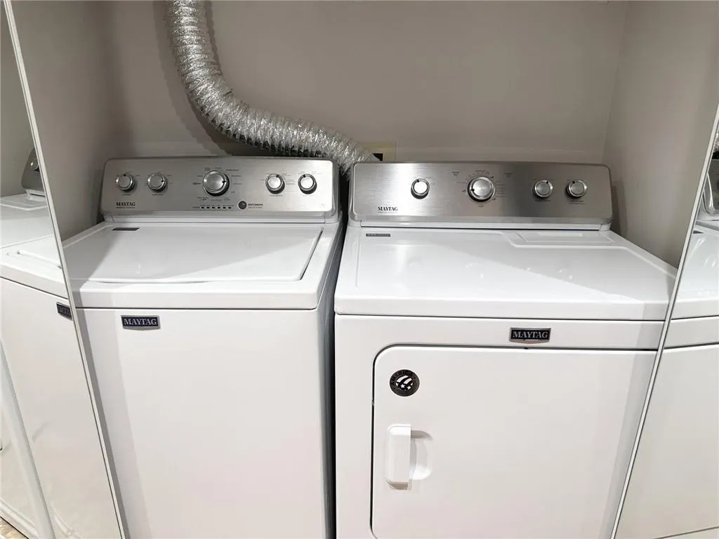 Washroom with washing machine and clothes dryer