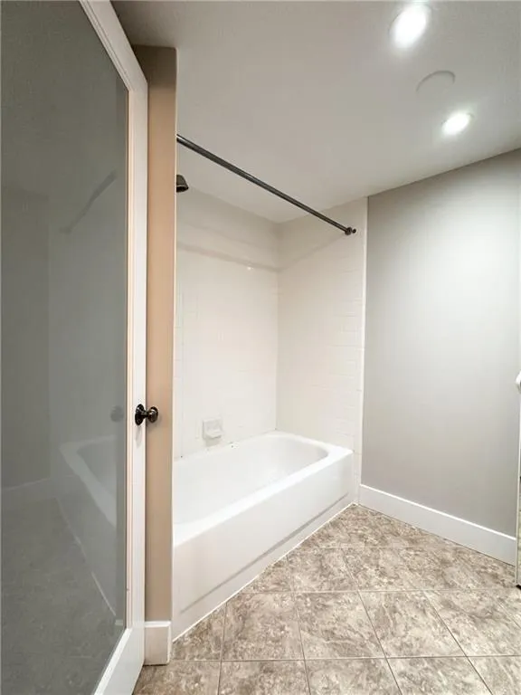 Full bathroom featuring shower / washtub combination, light tile patterned flooring, and recessed lighting