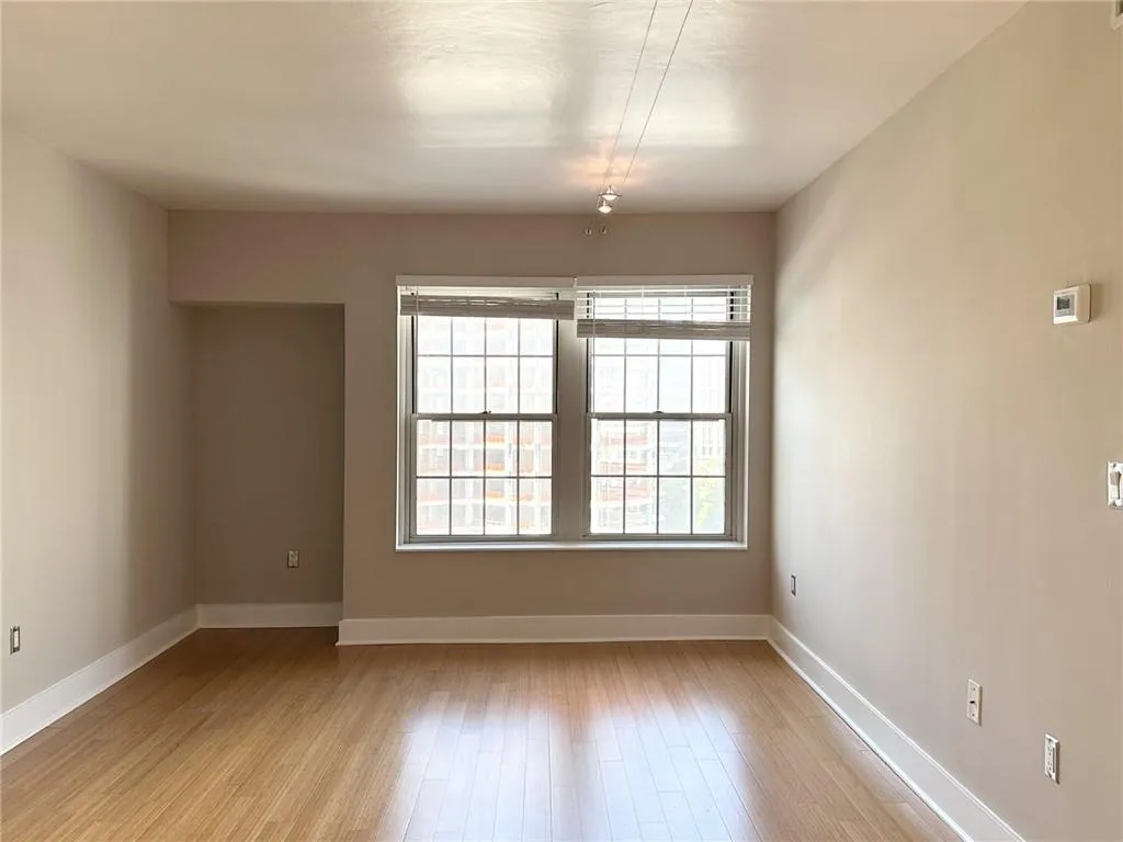 Spare room featuring light wood-style floors and baseboards